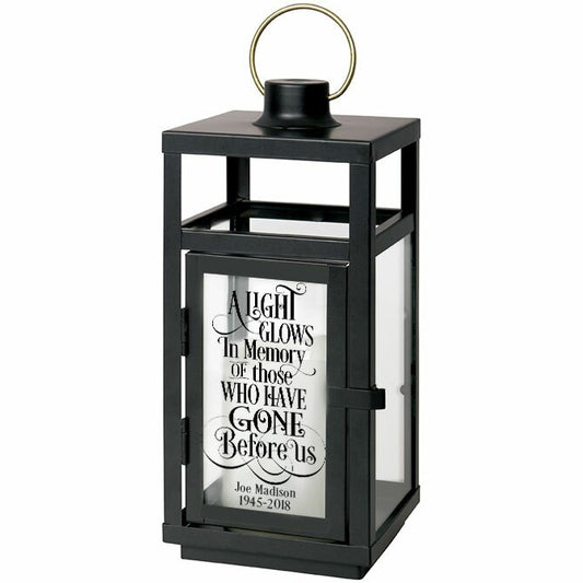 A Light Glows In Memory Black Lantern With LED Candle.